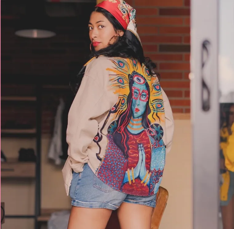 La Diosa — Deidad de colores sobre chaqueta clara